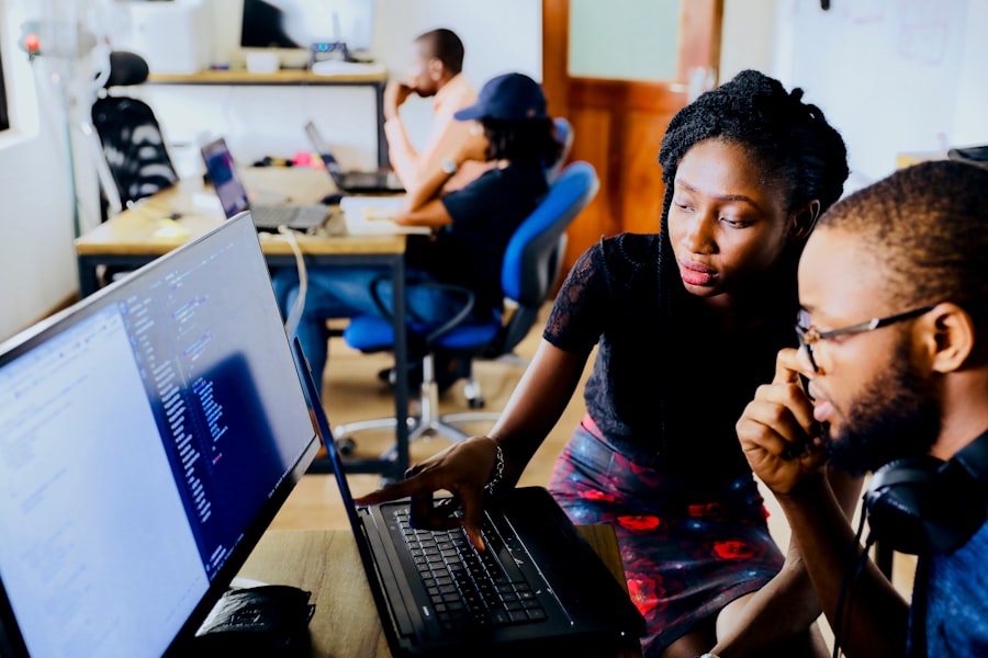 Two developers reviewing code together at a screen